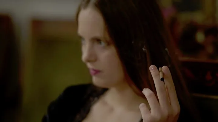 A woman with a cigarillo in the manor salon