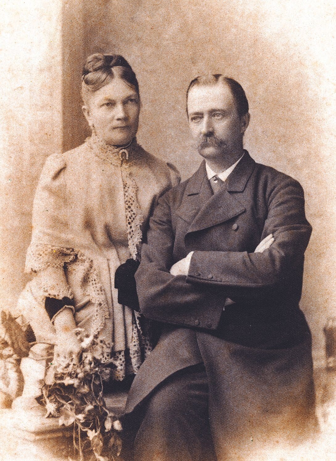 Count Juozapas and Countess Sofia Portrait Sepia studio portrait of a seated moustached man with arms crossed beside a woman in lace dress