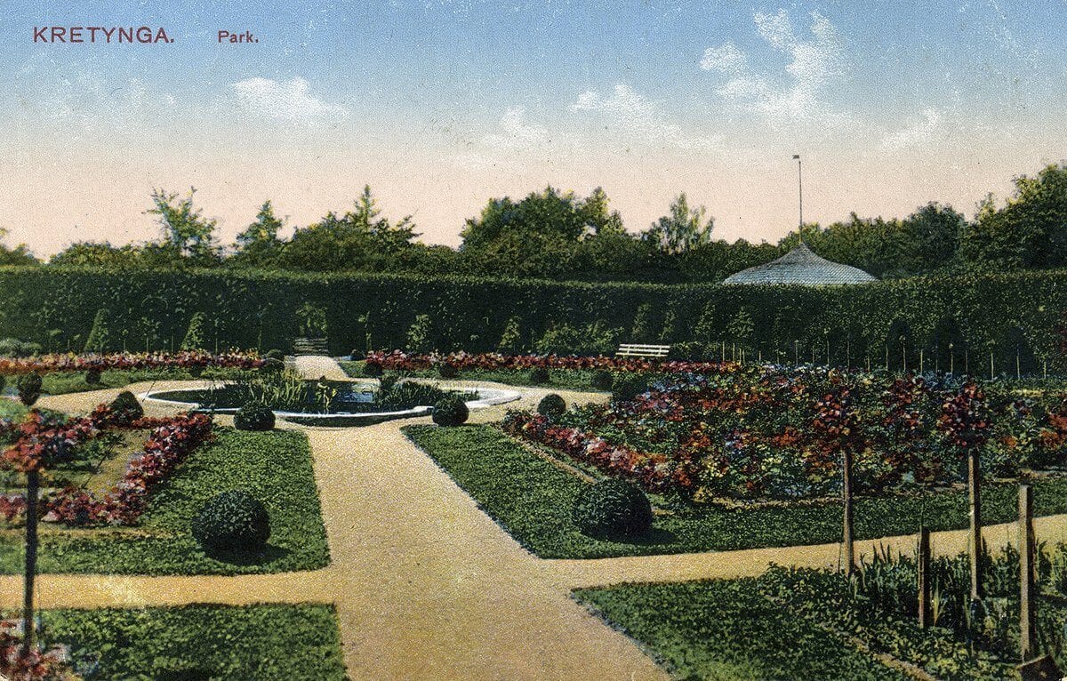 Kretinga Estate Park Postcard Hand-coloured postcard of a formal park with hedges, flower beds, clipped shrubs and a round pool