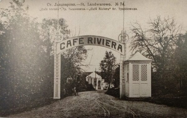 Vintage postcard showing an ornate arched gateway lettered Cafe Riviera with a small gatehouse and tree-lined drive